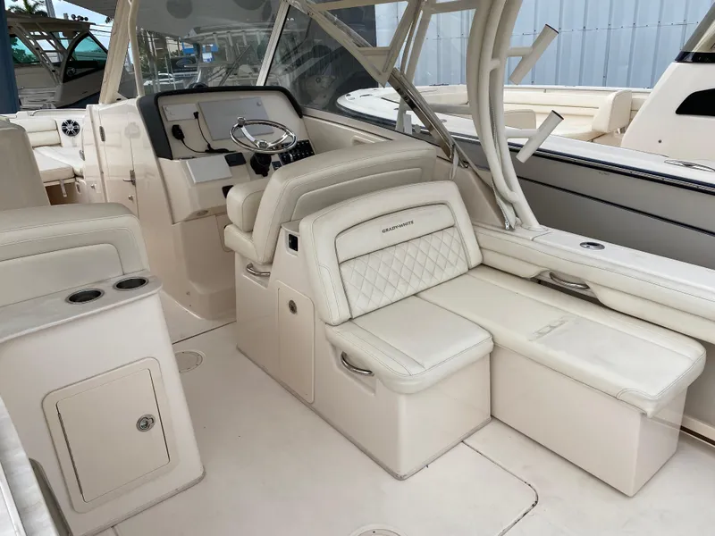 Slide: The Image of 2022 Grady-White Freedom 325 boat interior with luxurious seating and helm station. - 11