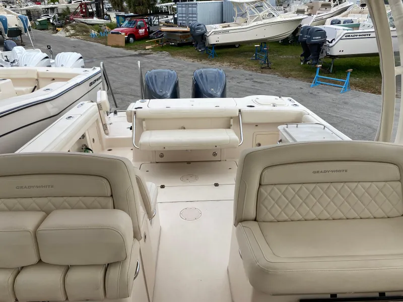 Slide: The Image of 2022 Grady-White Freedom 325 boat interior with dual engines and cushioned seating. - 12