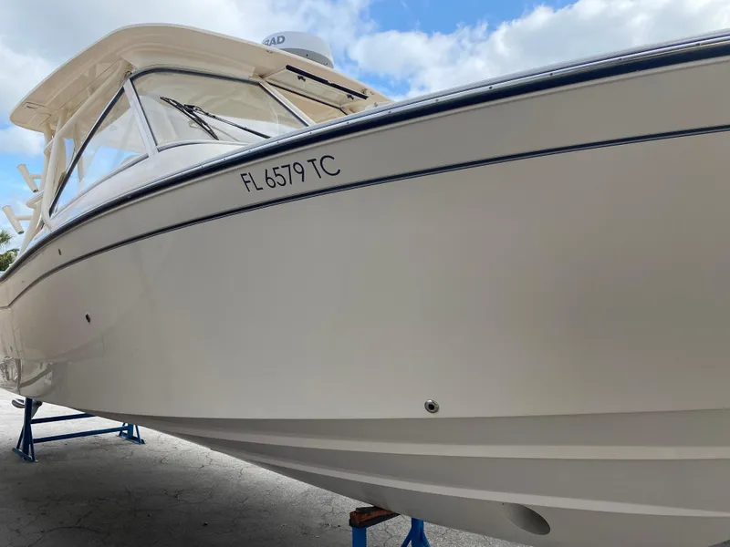 Slide: The Image of 2022 Grady-White Freedom 325 boat on stands, side view, clear sky background. - 3
