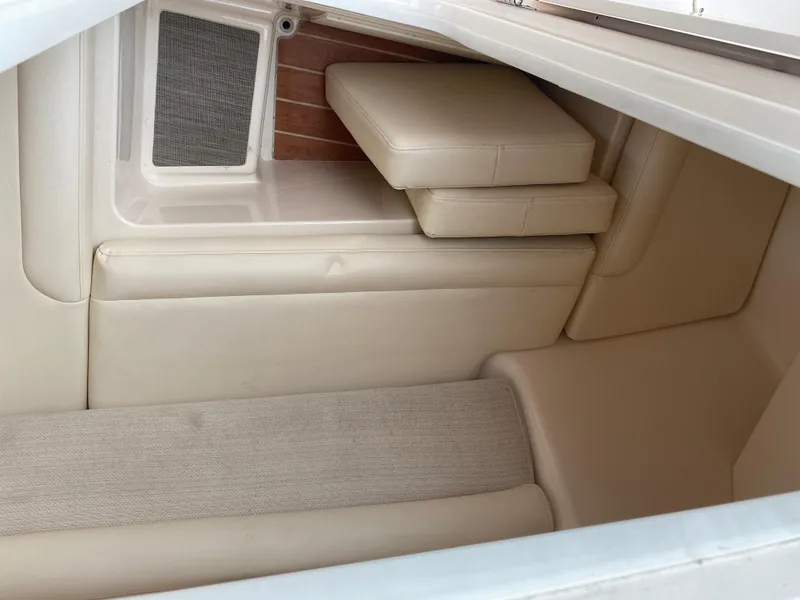 Slide: The Image of 2022 Grady-White Freedom 325 boat interior with cushioned seating and storage area. - 6