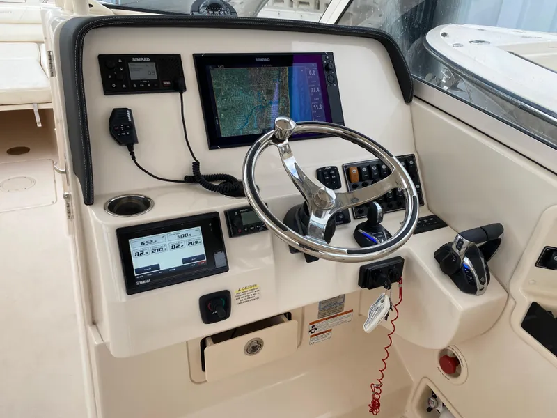 Slide: The Image of 2022 Grady-White Freedom 325 helm with advanced navigation and control systems. - 8