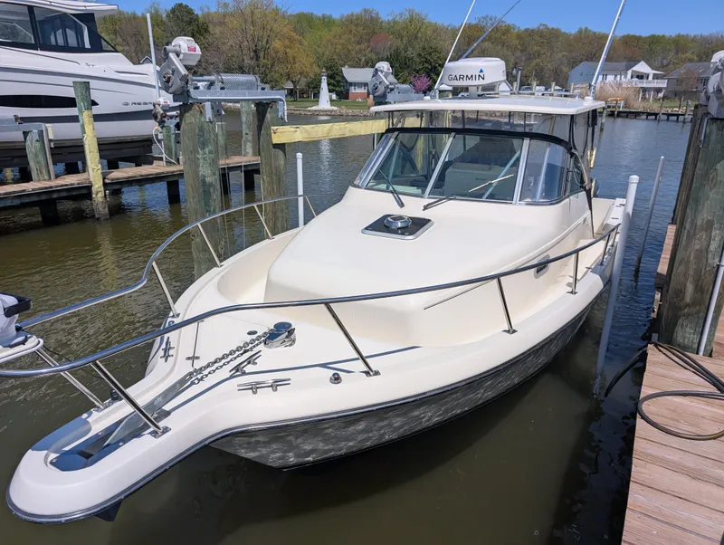 Slide: The Image of 2001 Pursuit 3070 Offshore Center Console boat docked in a marina. - 11