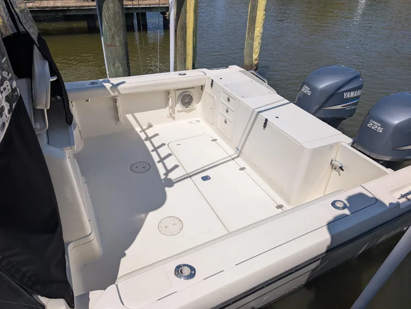 Slide: The Image of 2001 Pursuit 3070 Offshore Center Console boat with Yamaha engines, docked in a marina. - 12
