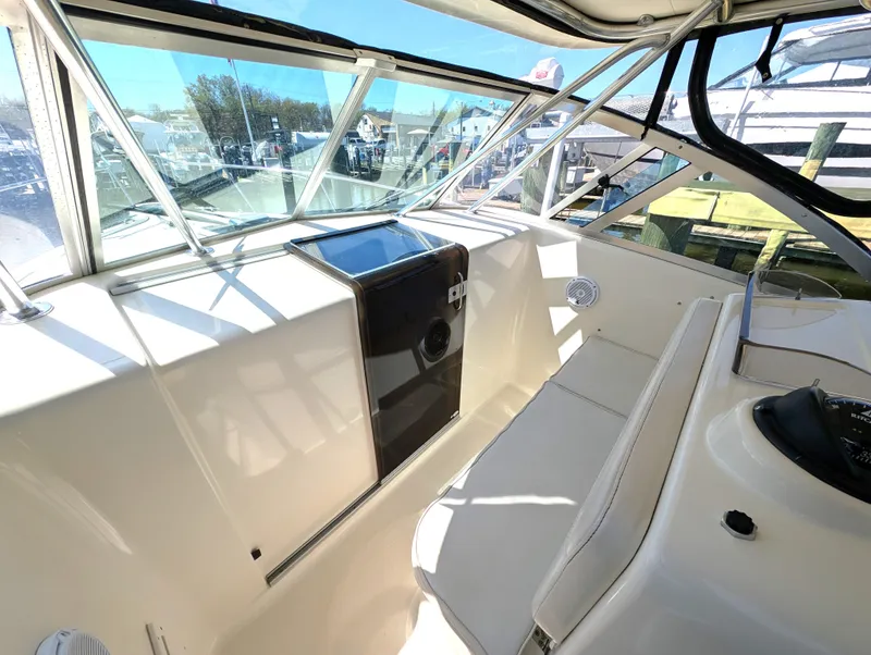 Slide: The Image of 2001 Pursuit 3070 Offshore Center Console interior with helm and seating area. - 19