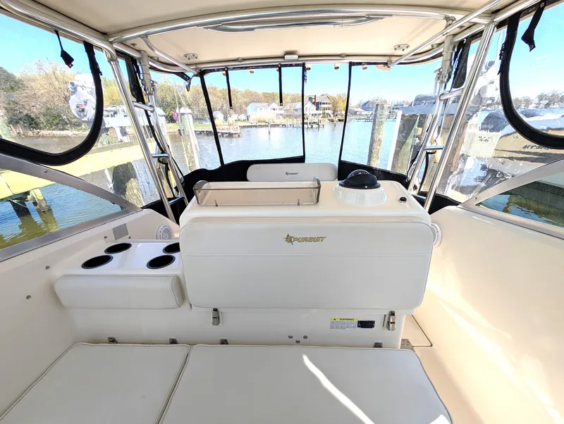 Slide: The Image of 2001 Pursuit 3070 Offshore Center Console boat interior with seating and console view. - 20