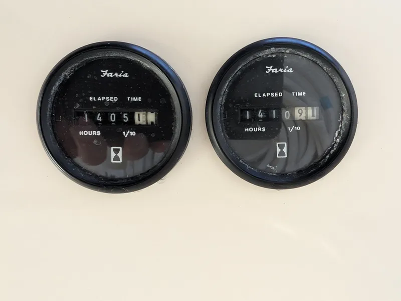 Slide: The Image of Hour meters on a 2001 Pursuit 3070 Offshore Center Console boat dashboard. - 29