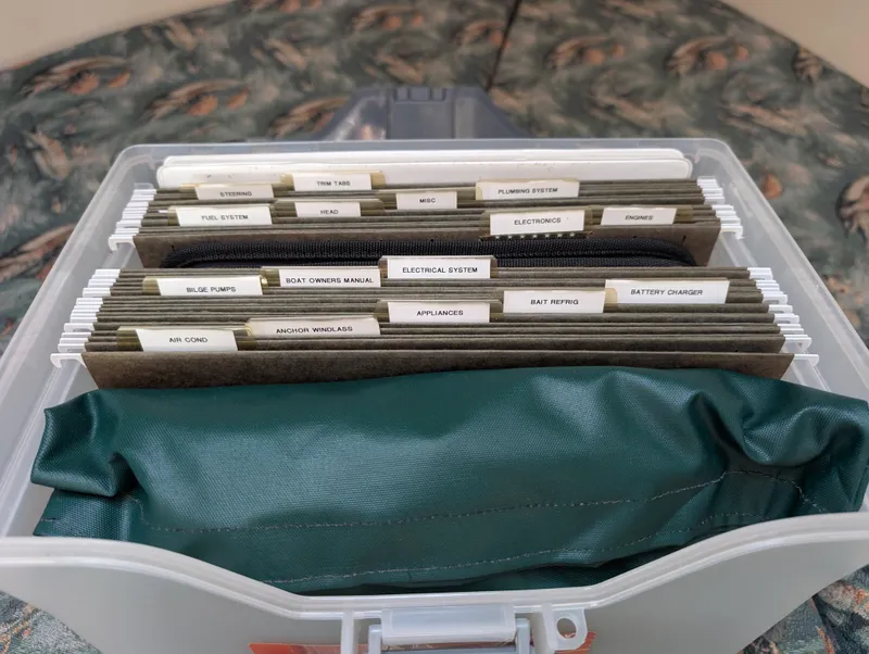 Slide: The Image of Organized boat maintenance files in a box for 2001 Pursuit 3070 Offshore Center Console. - 30