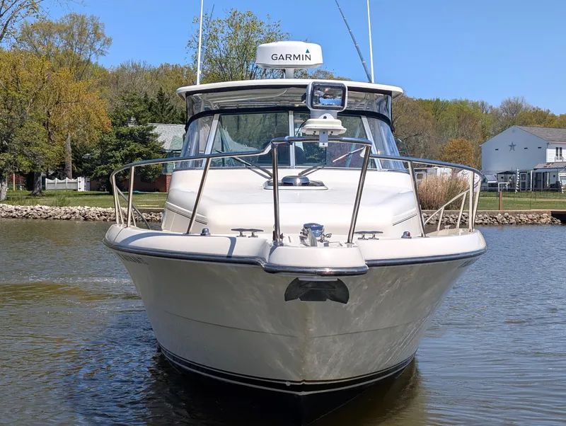 Slide: The Image of 2001 Pursuit 3070 Offshore Center Console boat on calm water, front view. - 8