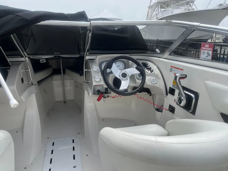 Slide: The Image of 2008 Larson 206 Sensa boat interior with steering wheel and dashboard controls. - 10