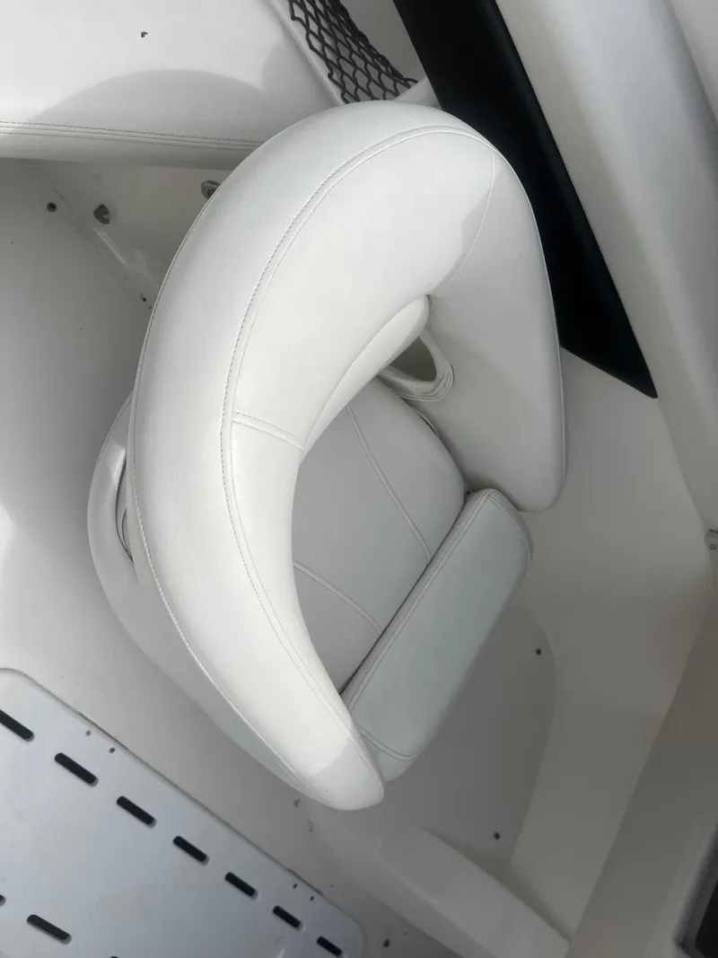 Slide: The Image of White leather seat in a 2008 Larson 206 Sensa boat interior. - 11