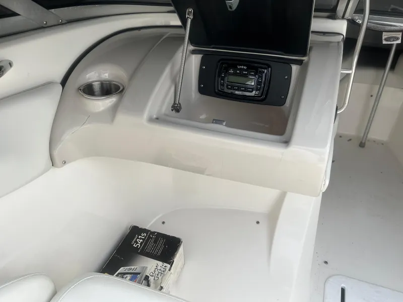 Slide: The Image of 2008 Larson 206 Sensa boat interior with stereo system and cup holder. - 13