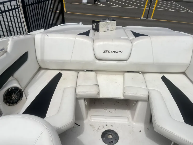 Slide: The Image of Interior of a 2008 Larson 206 Sensa boat with white seating and black accents. - 8