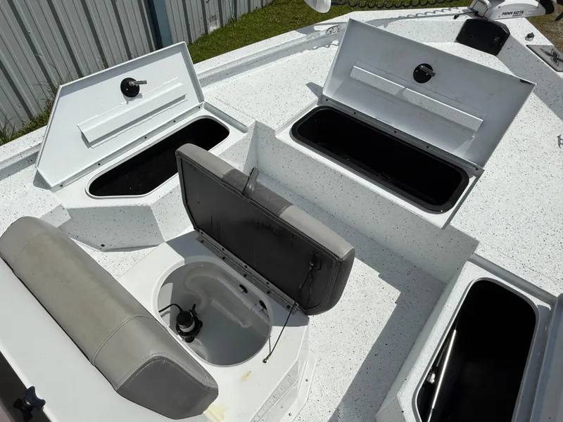 Slide: The Image of 2022 Express H20 boat with open storage compartments and seating. - 11