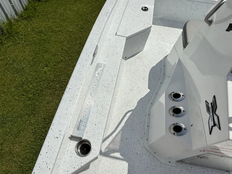 Slide: The Image of 2022 Express H20 boat deck with rod holders and clean white finish. - 12