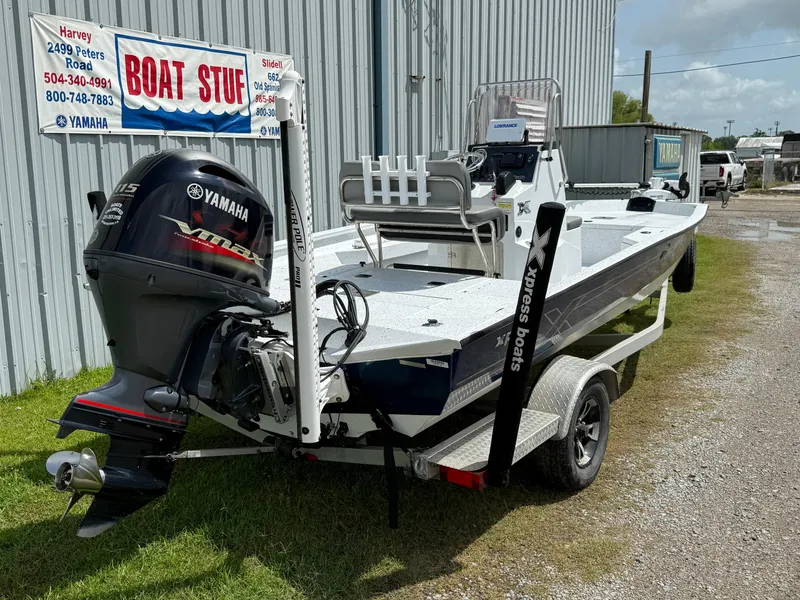 Slide: The Image of 2022 Express H20 boat with Yamaha outboard motor, parked near a boat dealership. - 5