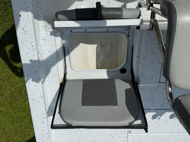 Slide: The Image of Foldable seat on 2022 Express H20 boat, featuring gray upholstery and speckled flooring. - 7