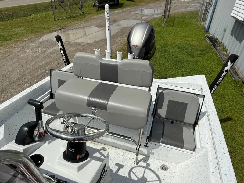 Slide: The Image of 2022 Express H20 boat interior with gray seating and steering wheel. - 8