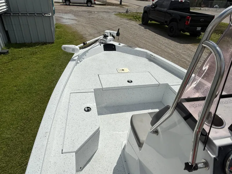 Slide: The Image of 2022 Express H20 boat with spacious deck and modern design, parked outdoors. - 9