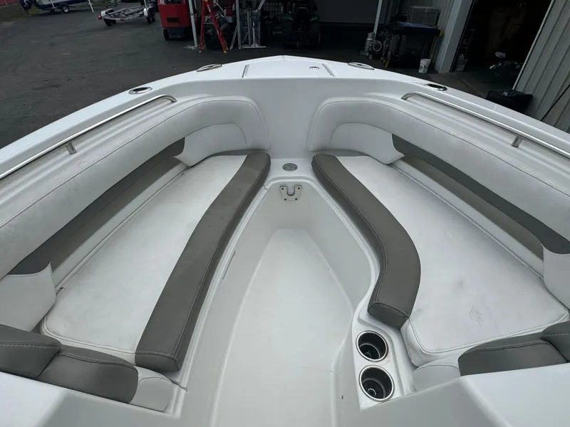 Slide: The Image of 2019 Albemarle 27 DC boat interior with cushioned seating and cup holders. - 11