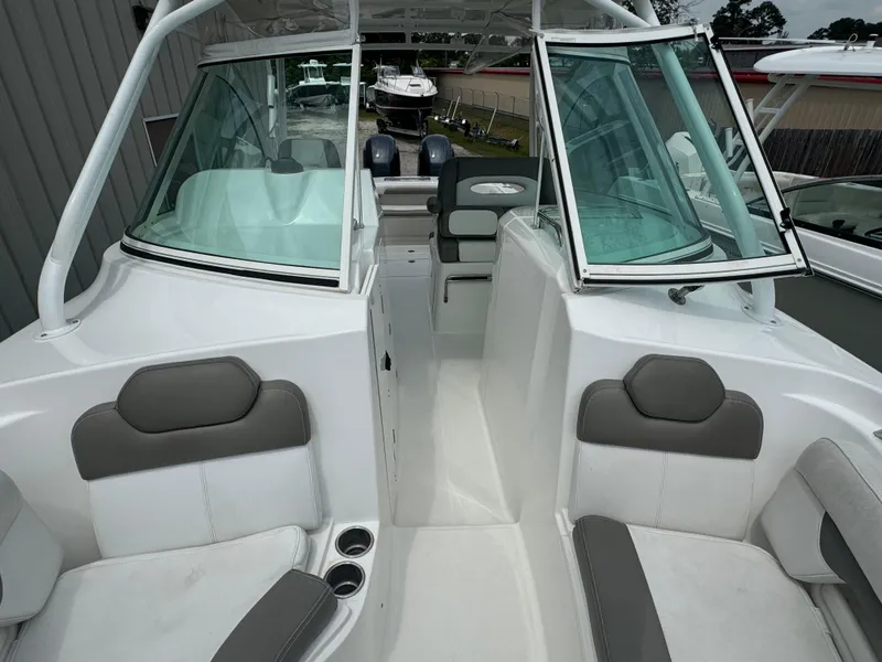 Slide: The Image of 2019 Albemarle 27 DC boat interior with gray seating and dual windshields. - 12