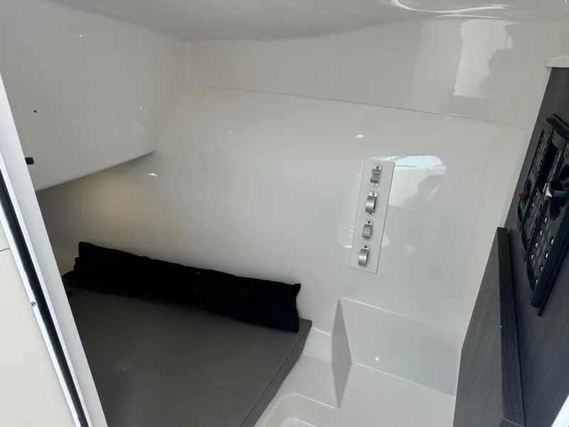 Slide: The Image of 2019 Albemarle 27 DC cabin interior with control panel and cushioned seating. - 15