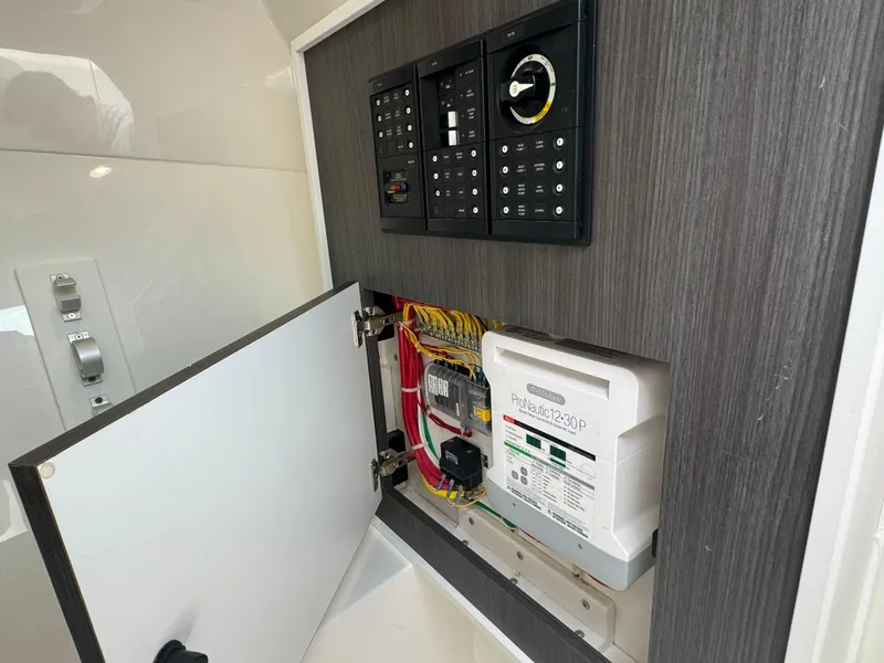 Slide: The Image of Electrical panel and wiring inside a 2019 Albemarle 27 DC boat. - 16