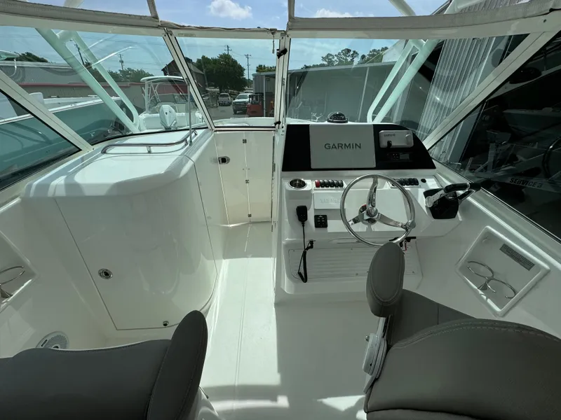 Slide: The Image of 2019 Albemarle 27 DC boat cockpit with Garmin navigation system and seating. - 17