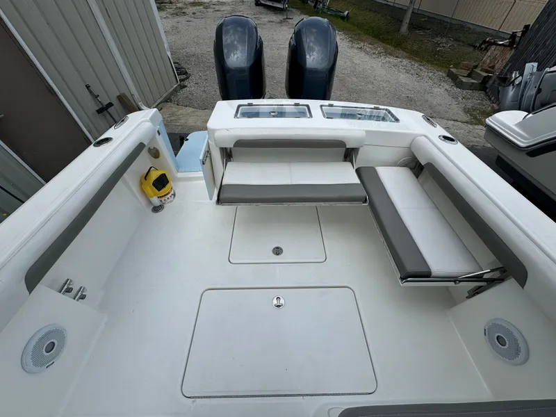 Slide: The Image of 2019 Albemarle 27 DC boat interior with seating and dual engines. - 24