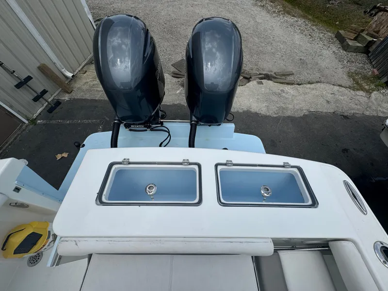 Slide: The Image of 2019 Albemarle 27 DC boat with dual outboard engines and storage compartments. - 25
