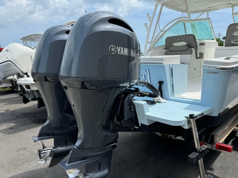 Slide: The Image of 2019 Albemarle 27 DC boat with twin Yamaha outboard engines, docked on a sunny day. - 26