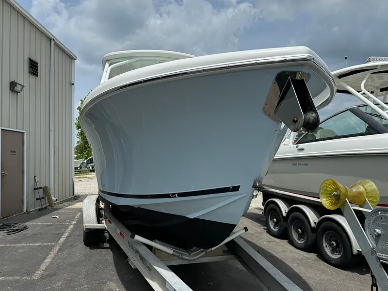 Slide: The Image of 2019 Albemarle 27 DC boat on trailer, parked outdoors near a building. - 7
