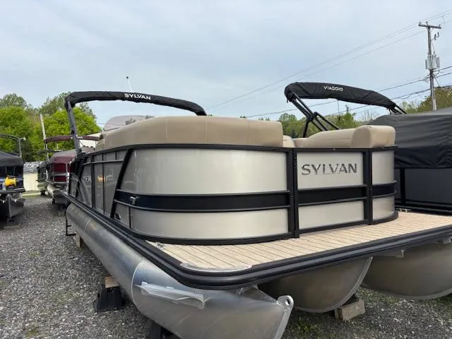 The Image of 2025 Sylvan X-3 CLZ pontoon boat with sleek design, parked outdoors. - 1