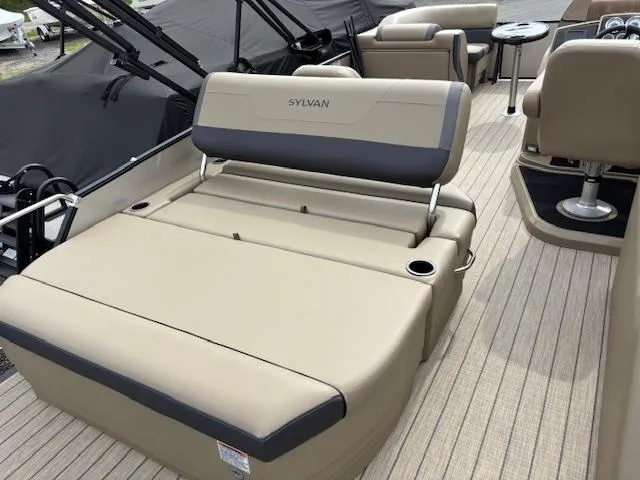 Slide: The Image of 2025 Sylvan X-3 CLZ boat interior with beige seating and cup holders. - 11
