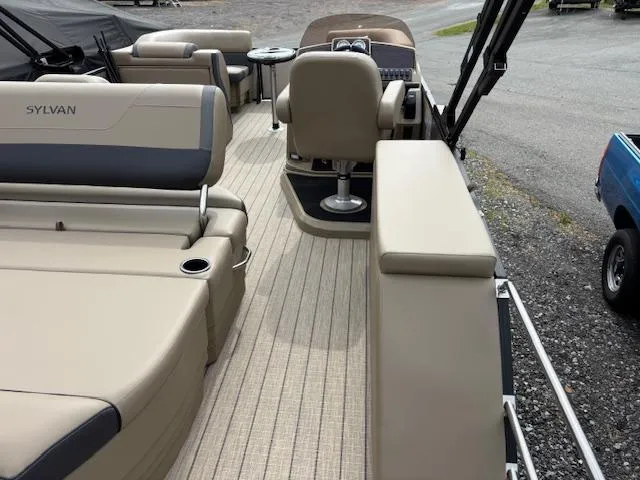 Slide: The Image of 2025 Sylvan X-3 CLZ boat interior with beige seating and modern design. - 13