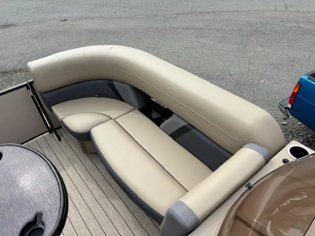 Slide: The Image of 2025 Sylvan X-3 CLZ boat interior with beige and gray seating. - 18
