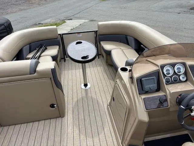 Slide: The Image of 2025 Sylvan X-3 CLZ boat interior with beige seating and modern dashboard. - 3