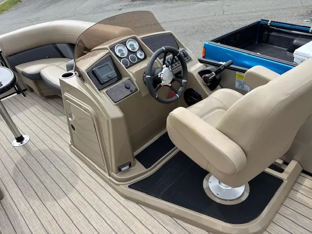 Slide: The Image of 2025 Sylvan X-3 CLZ boat interior with steering console and seating. - 5