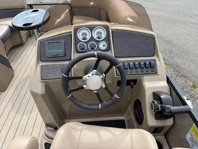 Slide: The Image of 2025 Sylvan X-3 CLZ boat dashboard with steering wheel and control panel. - 6