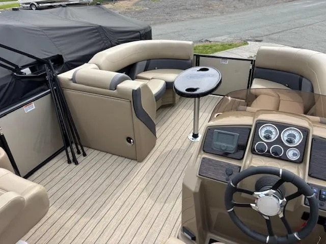 Slide: The Image of 2025 Sylvan X-3 CLZ boat interior with beige seating and modern dashboard. - 7