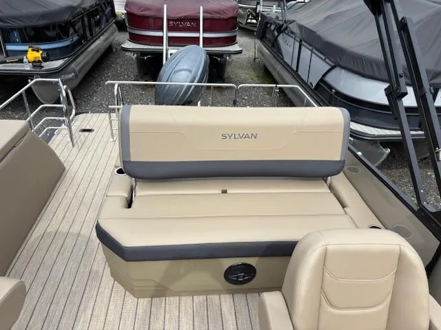 Slide: The Image of 2025 Sylvan X-3 CLZ boat interior with beige seating and sleek design. - 9