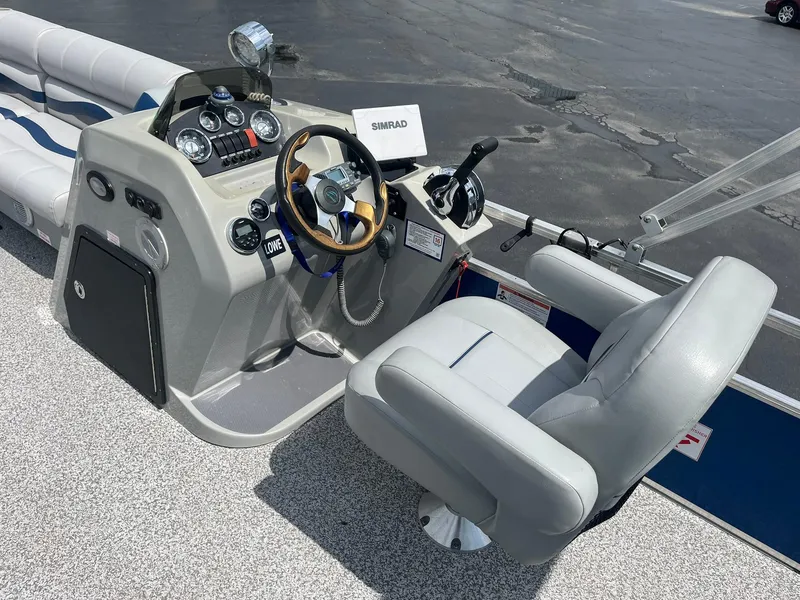 Slide: The Image of 2019 Lowe Ultra 182 Fish & Cruise boat cockpit with steering wheel and controls. - 12