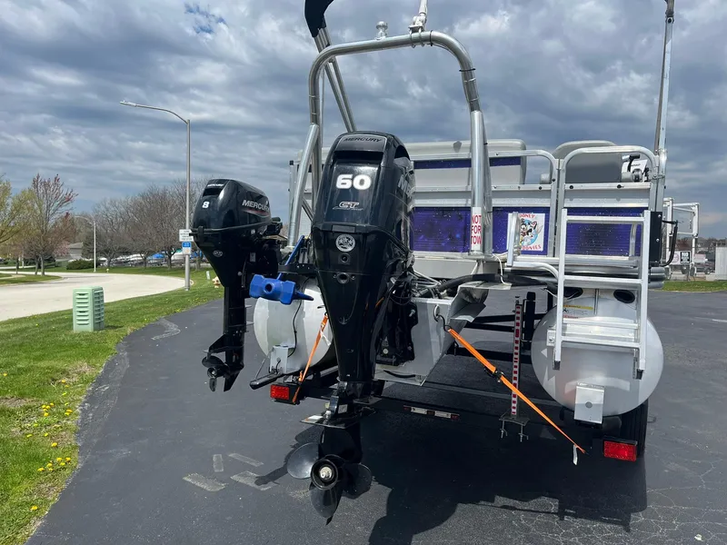 Slide: The Image of 2019 Lowe Ultra 182 Fish & Cruise boat with dual outboard motors on a trailer. - 4