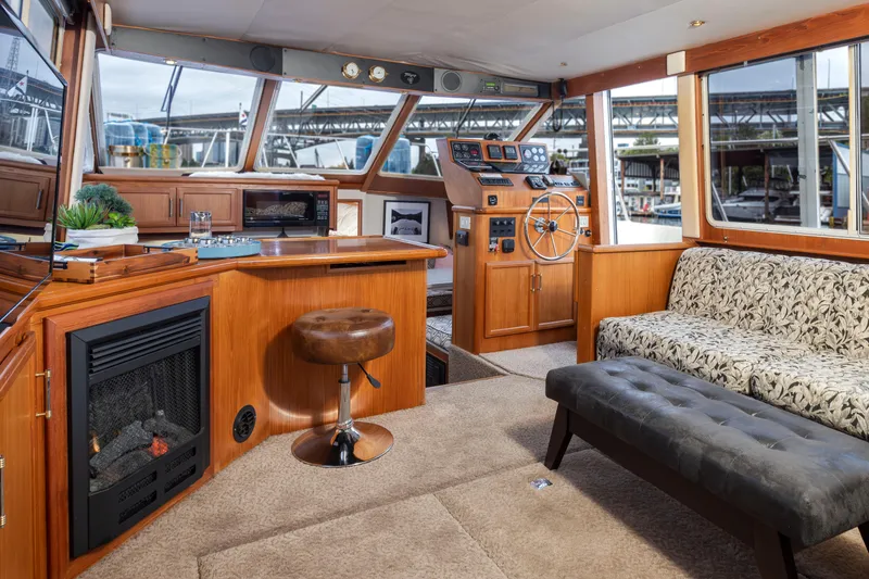 Slide: The Image of Interior of 1995 Tollycraft 45 CPMY yacht with helm, seating, and fireplace. - 17