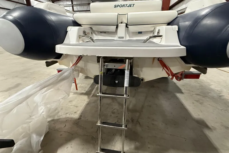 Slide: The Image of 2017 Williams Jet Tenders Sportjet 520 with ladder in a warehouse setting. - 21