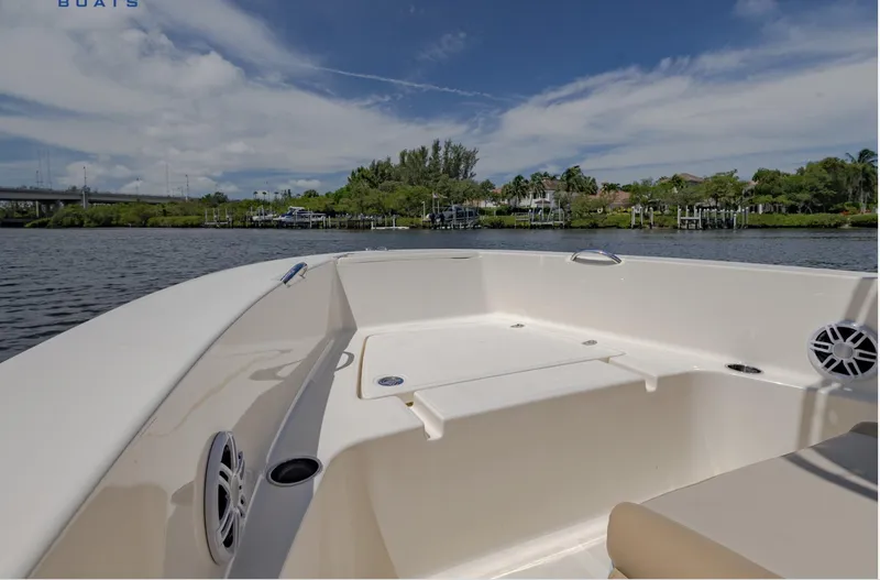 Slide: The Image of 2023 Scout 195 Sportfish boat on calm water with clear sky background. - 4