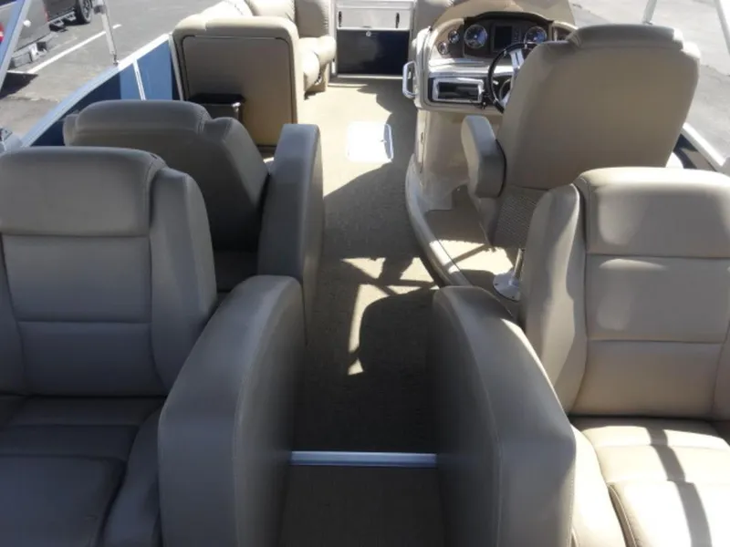 Slide: The Image of 2014 Sanpan SP 2500 DL pontoon boat interior with beige seating and steering console. - 11