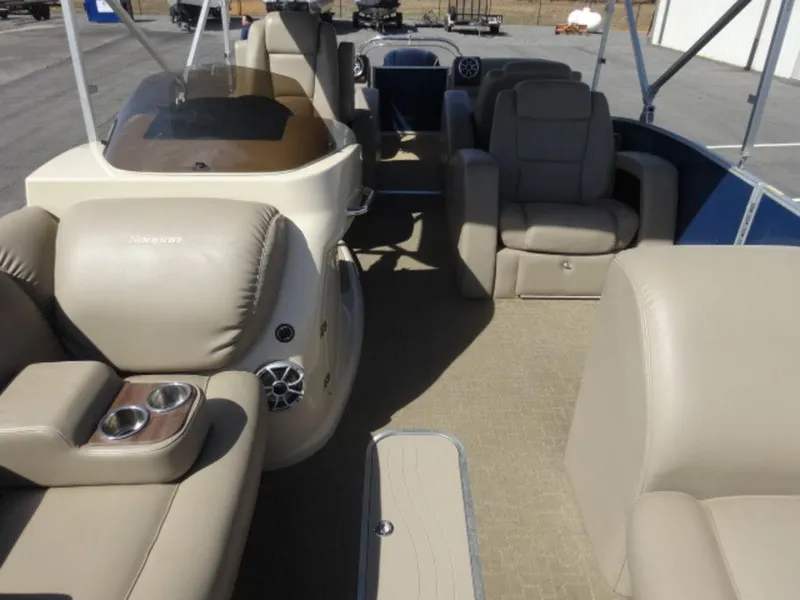 Slide: The Image of 2014 Sanpan SP 2500 DL pontoon boat interior with beige seating and cup holders. - 5