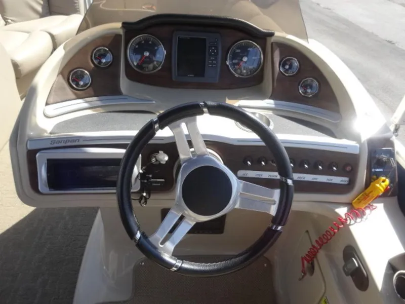 Slide: The Image of 2014 Sanpan SP 2500 DL boat dashboard with steering wheel and control panel. - 8