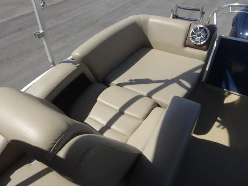 Slide: The Image of 2014 Sanpan SP 2500 DL boat interior with beige seating and speaker. - 9