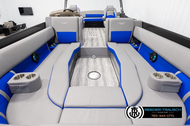Slide: The Image of 2025 Bennington 25 LTSBSE boat interior with gray and blue seating, cup holders, and modern design. - 12